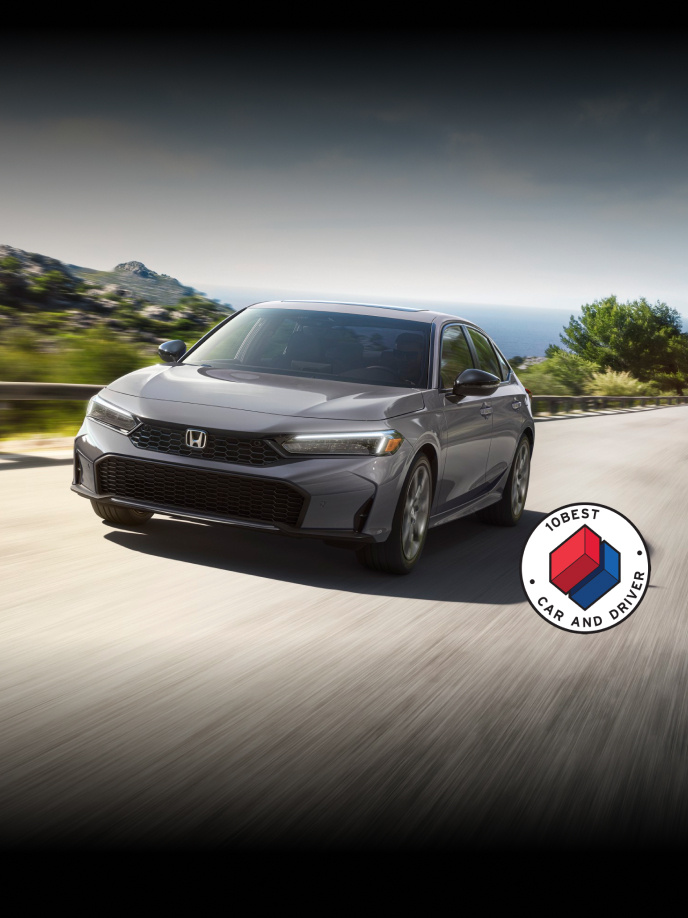 2026 Honda Civic Sedan Sport Touring Hybrid in Urban Gray Pearl front view with overlapping Car and Driver 10Best logo (Compact Sedan).