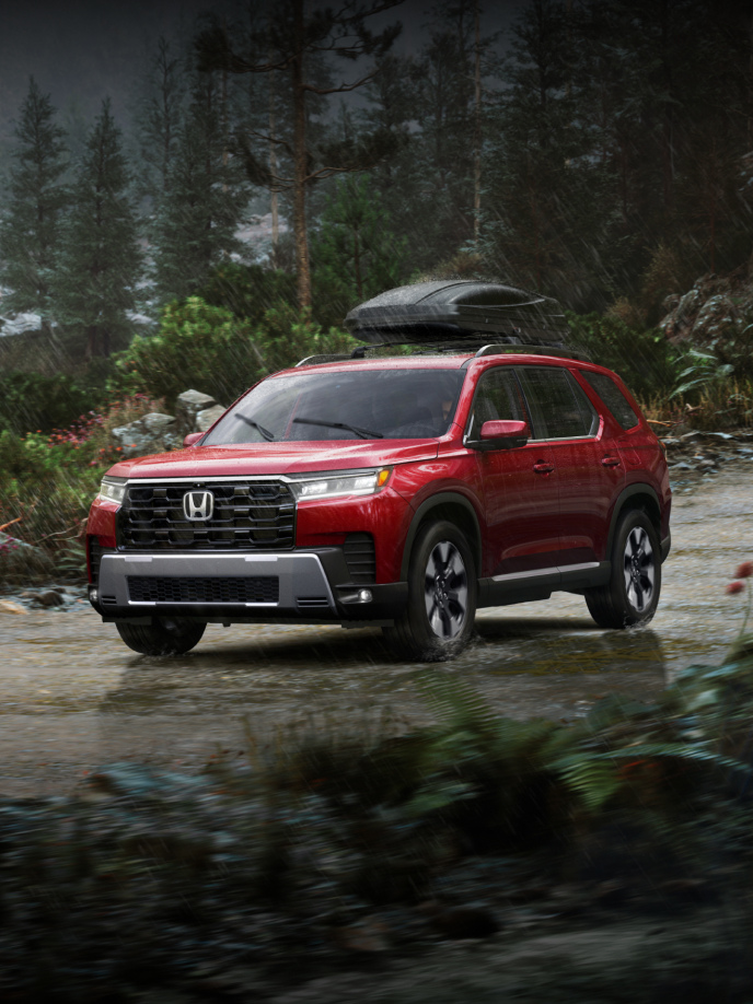 2026 Honda Pilot Elite shown in Radiant Red Metallic II with Honda Genuine Accessories