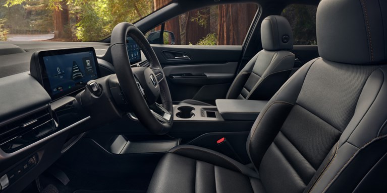 2026 Honda Prologue Elite interior, featuring the cabin, dashboard, steering wheel, and seating area from a side view.
