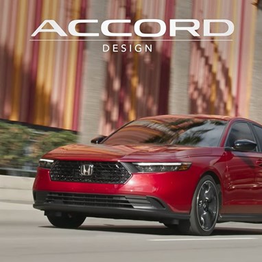 2026 Honda Accord Touring Hybird in Radiant Red Metallic in minimalistic urban environment.
