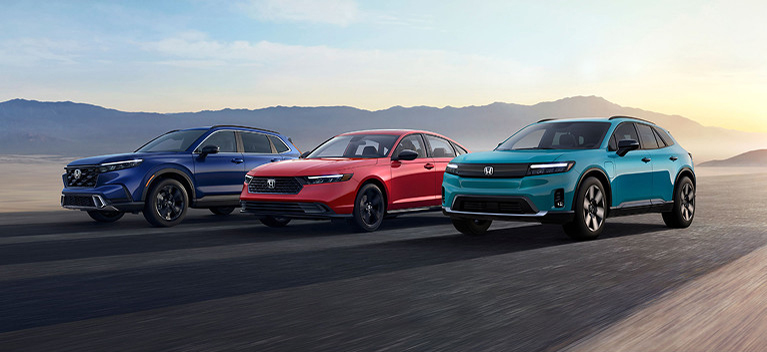 2025 Honda CR-V Hybrid, Honda Accord Hybrid and Honda Prologue in a street driving side by side